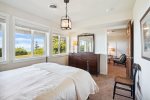 Downstairs bedroom with queen bed and ocean views at Sunset Cove